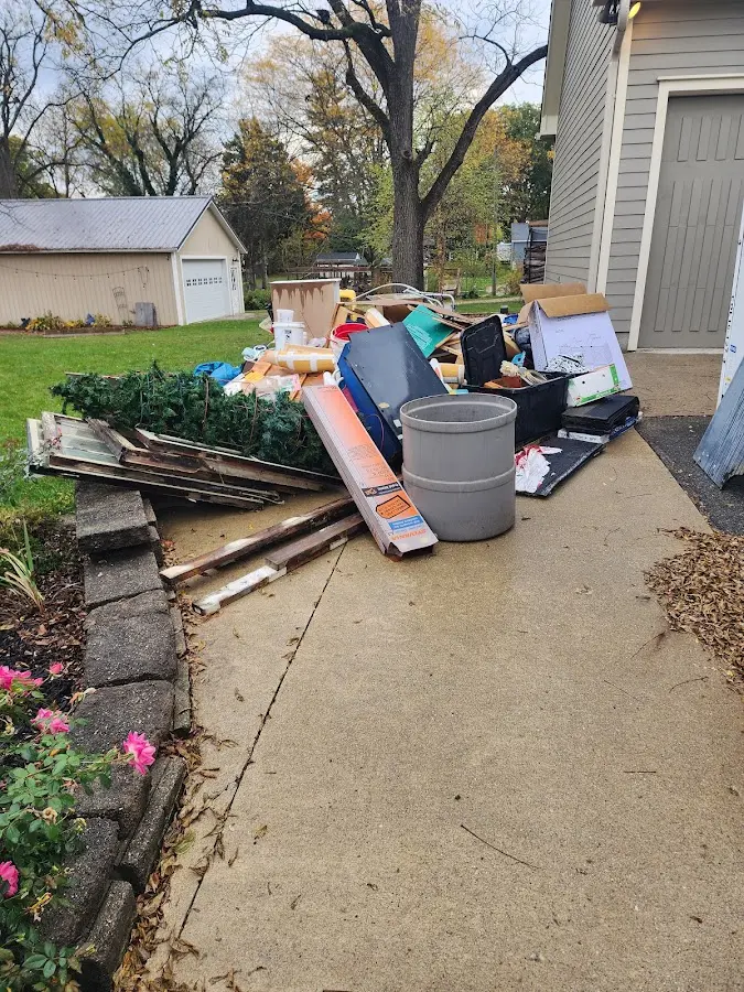 Dumpster being loaded with debris for 10 Yard Dumpster Rental in Wyoming